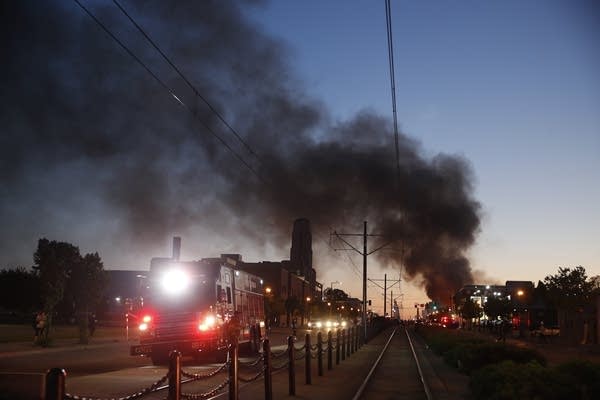 Fire burns in the distance during demonstrations 