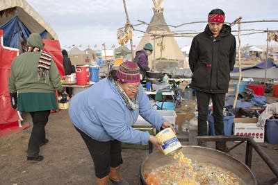 Winona Kasto adds golden hominy to homemade soup.