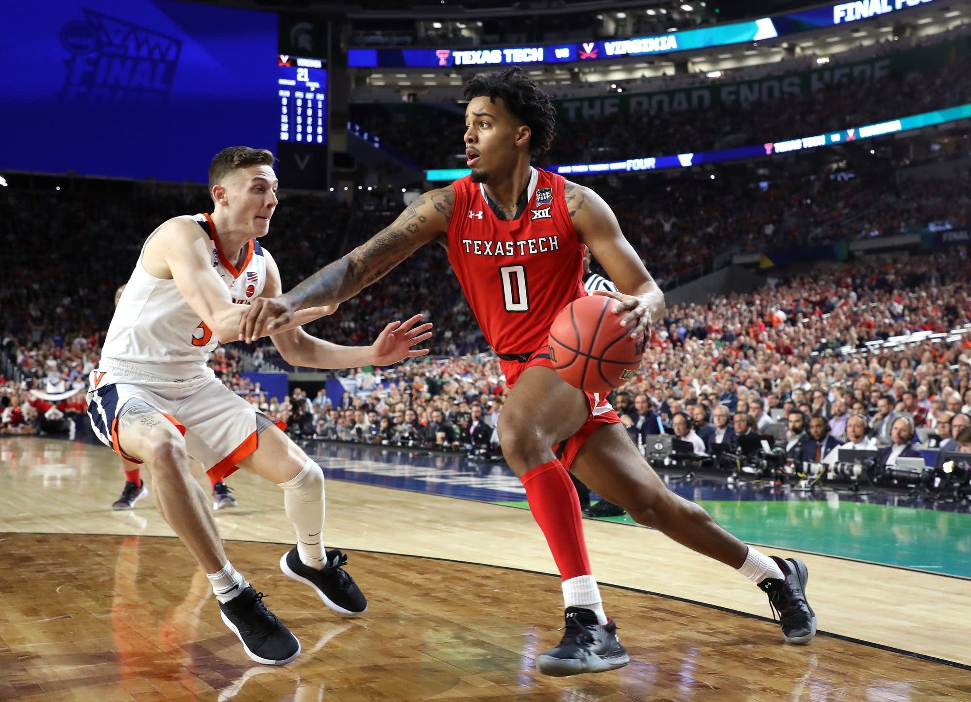 Kyler Edwards (0) of Texas Tech is defended by Kyle Guy (5) of Virginia