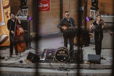 Wild Horses perform on an outdoor stage.