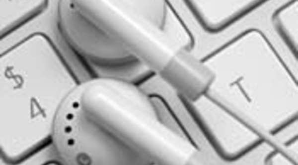 MP3 player headphones on a keyboard. The changes in the music industry precipitated by the MP3 have only continued with the rise of online streaming. 