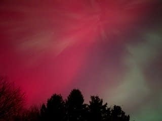 Red and green lights in a night sky.