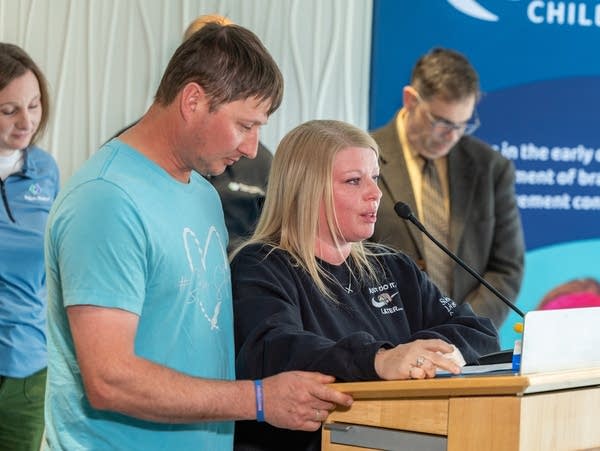 Two people speak at a podium