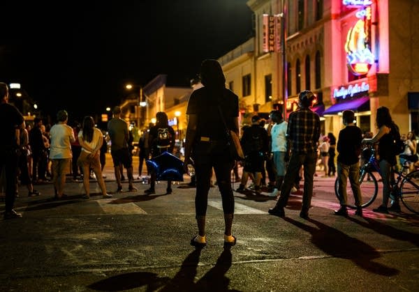 A group of people stands in the street