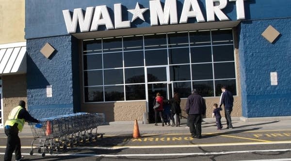 Customers walk outside a Walmart store on November 17, 2012 in Norwalk, Connecticut.