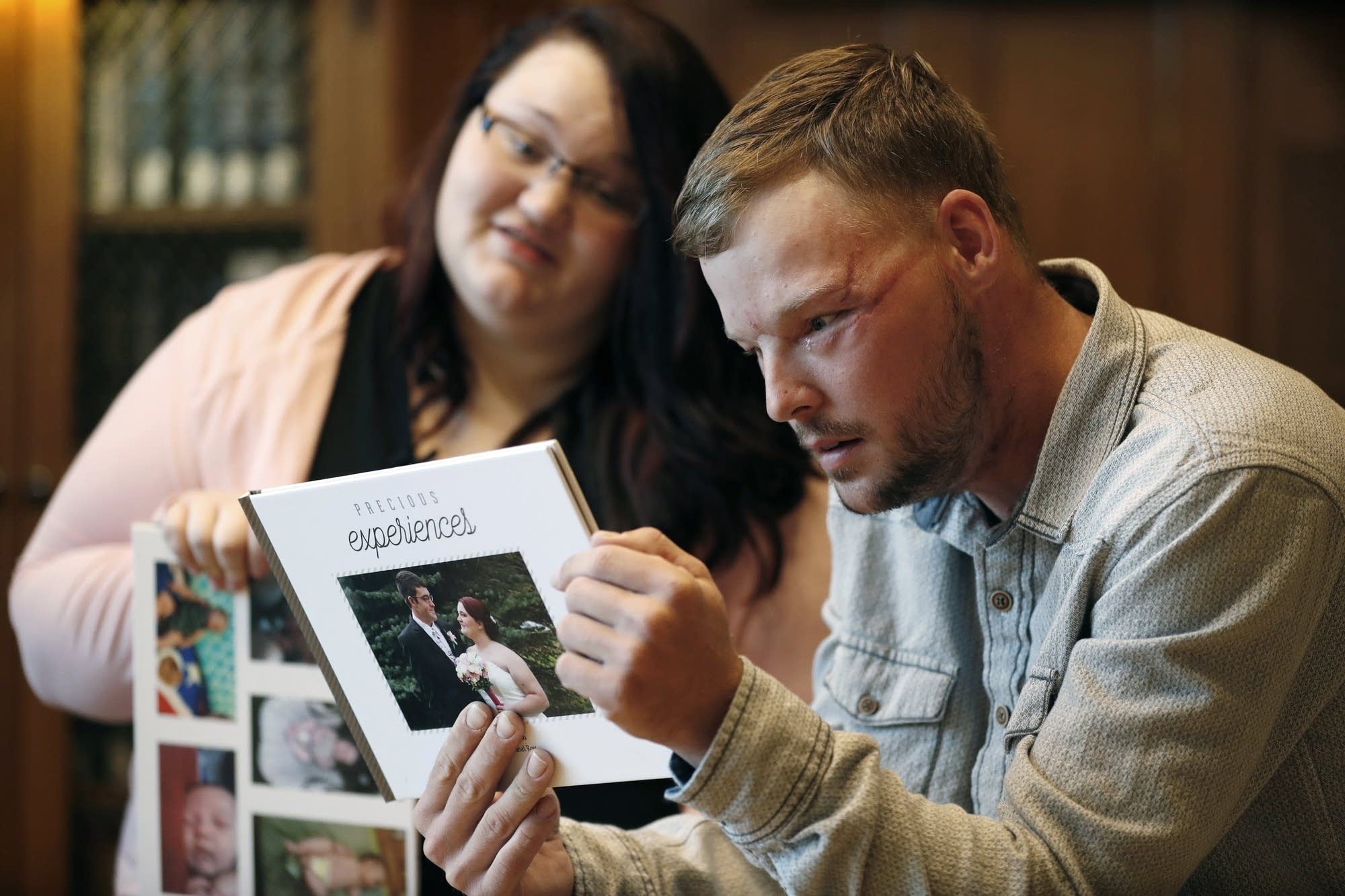 Lilly Ross, left, shows her family photos to Andy Sandness.