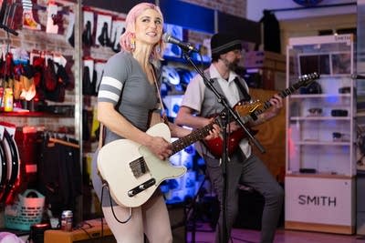 Woman playing guitar and smiling