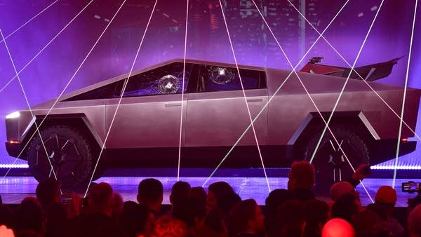 People take pictures of the newly unveiled all-electric battery-powered Tesla's Cybertruck with shattered windows after a failed resistance test, at Tesla Design Center in Hawthorne, California on November 21, 2019. 