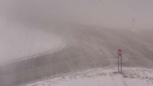 Heavy snow and gusty winds cause blizzard conditions along a highway