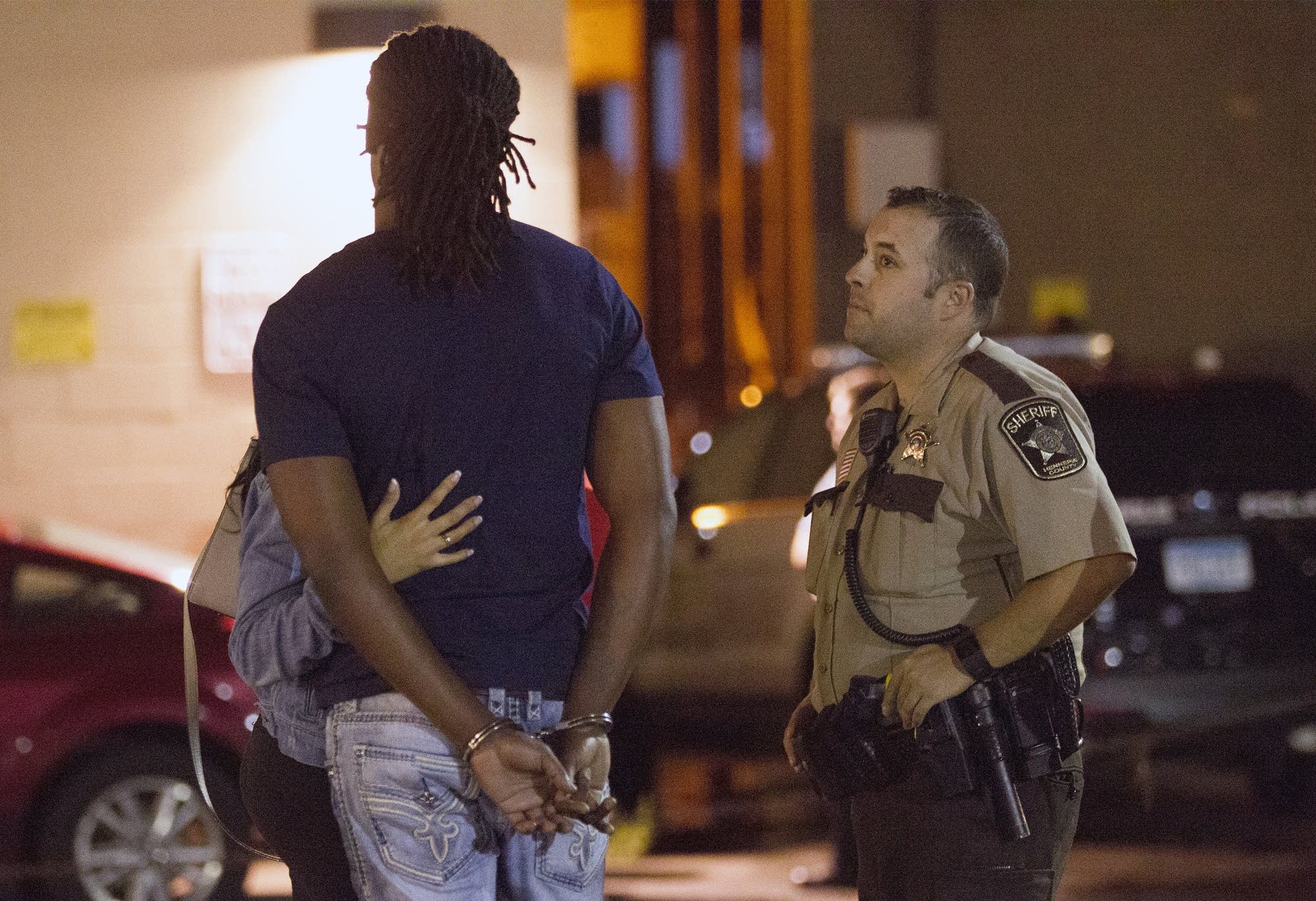 A Hennepin County sheriff listens as a suspect describes an incident.