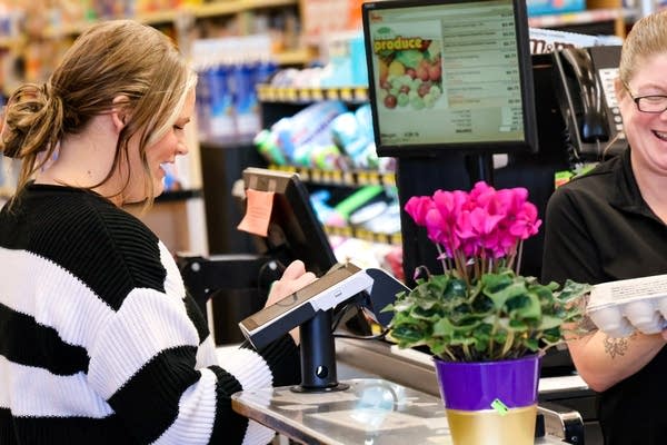 woman paying for groceries
