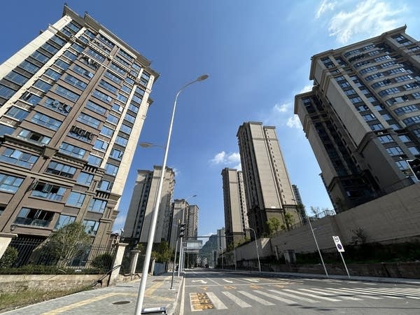 Several condo high-rise buildings viewed from the ground.