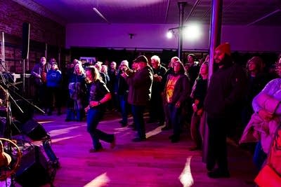 Music fans dancing and clapping during a set of live music