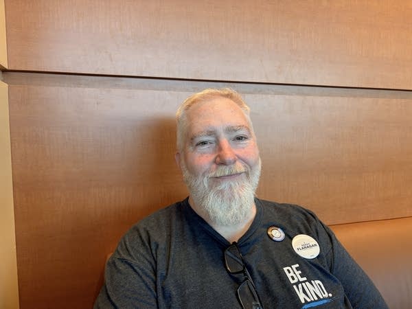 A man smiles for a photo