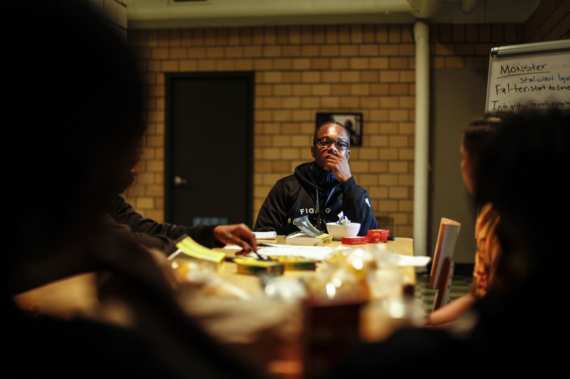 Morgan McDonald Sr. sits with kids from the book club.