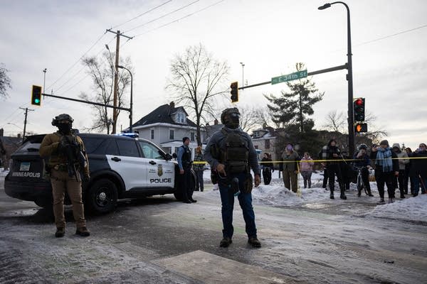 Officers stand behind a police line