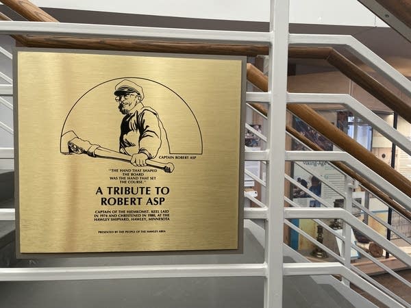 A plaque reads "A Tribute to Robert Asp" on a stairway.