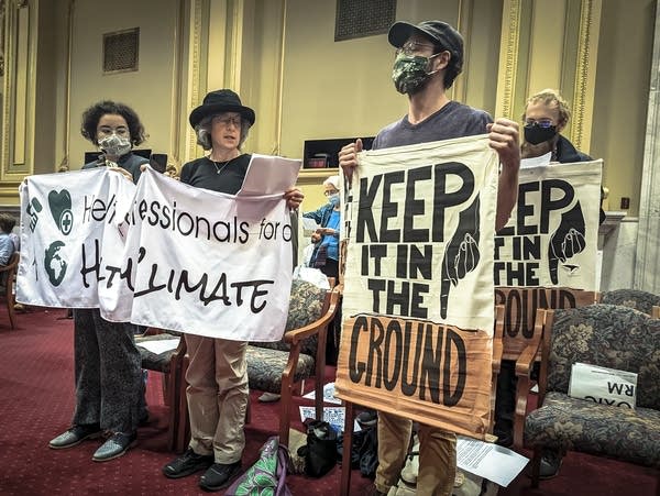 Protesters hold a banner