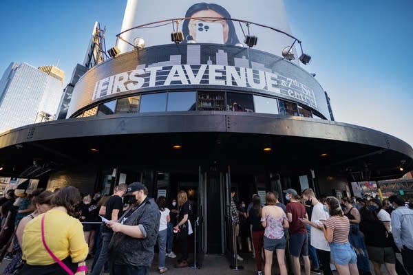 Fans gather outside a club waiting to get inside