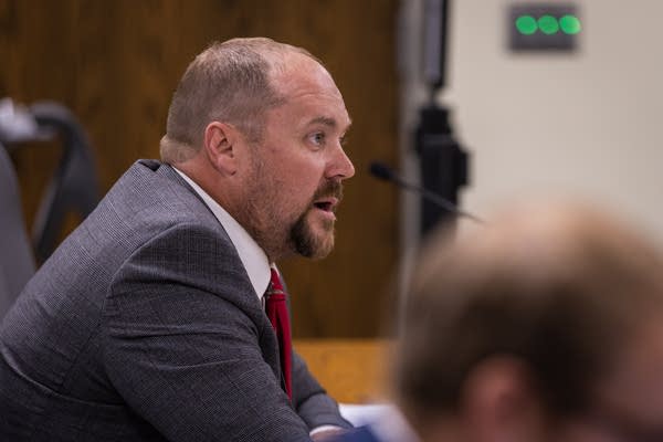 An attorney speaks into a mic