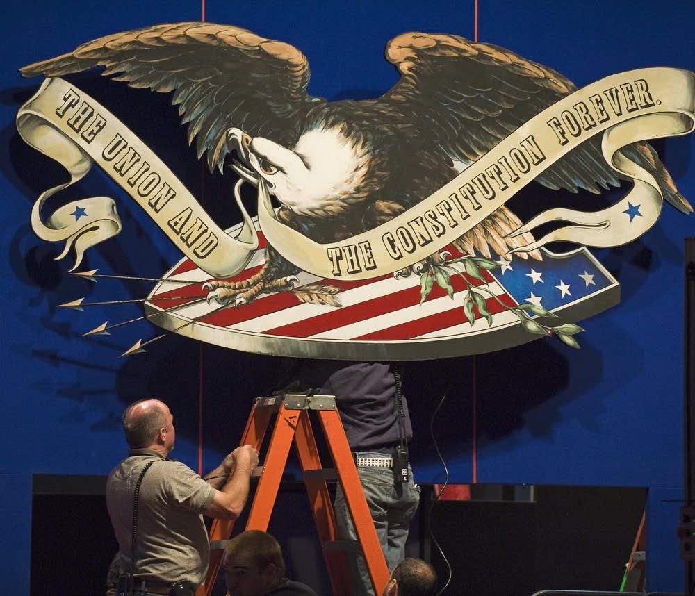 Stage crew members prepare for debate