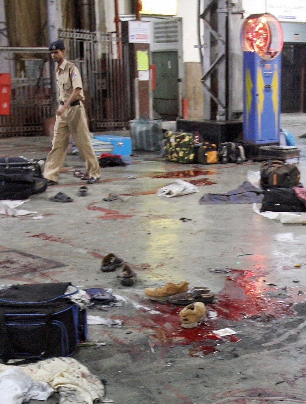An Indian policeman checks the shooting