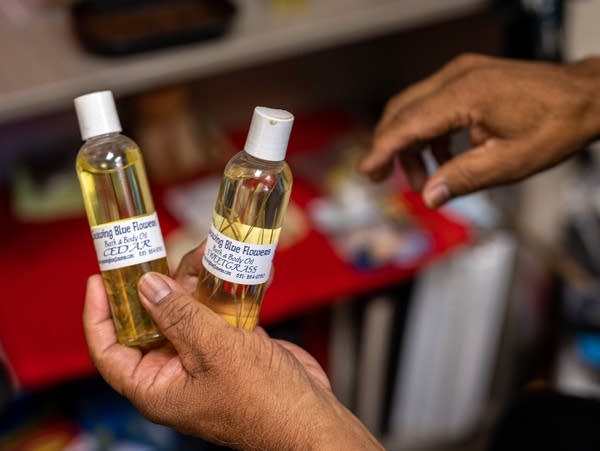 A person holds two bottles of medicine oils