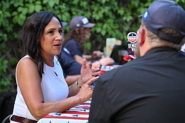 A woman talks at a table