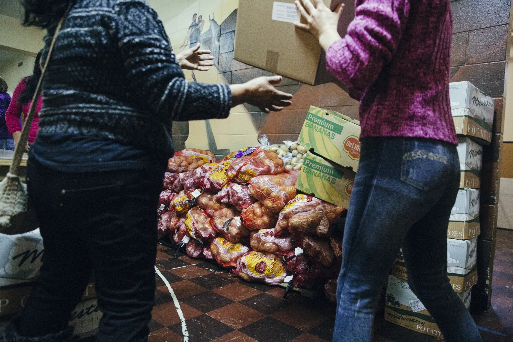 Volunteers and community members pass food along human chain