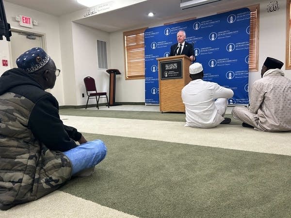 Gov. Tim Walz speaks at a poidum.