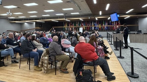 A crowd of people attend a city meeting