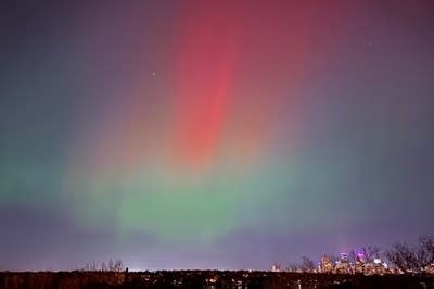 Green and red lights hang in the sky.