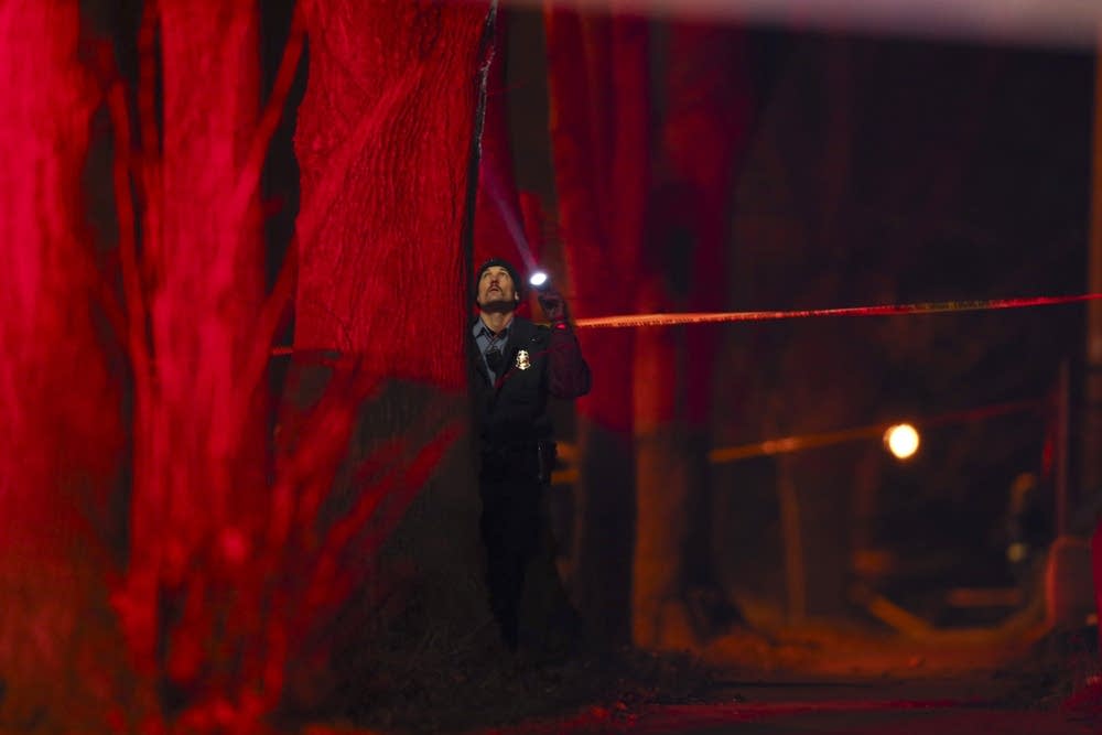 Minneapolis police officer investigates shooting.