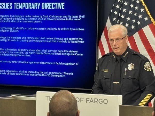 A police chief gives a presentation with a slideshow.