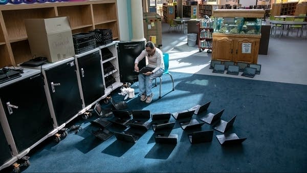 A tech support specialist cleans Chromebooks in September while preparing for the start of school at Newfield Elementary School in Stamford, Connecticut.