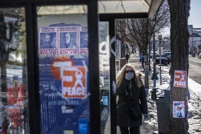 Posters depicting Alex Pretti and Renee Macklin Good are pasted on a wall