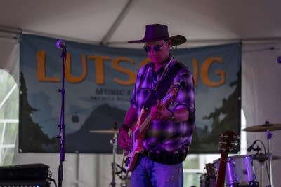a man playing bass on stage