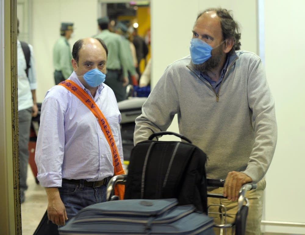 Air passengers wear masks