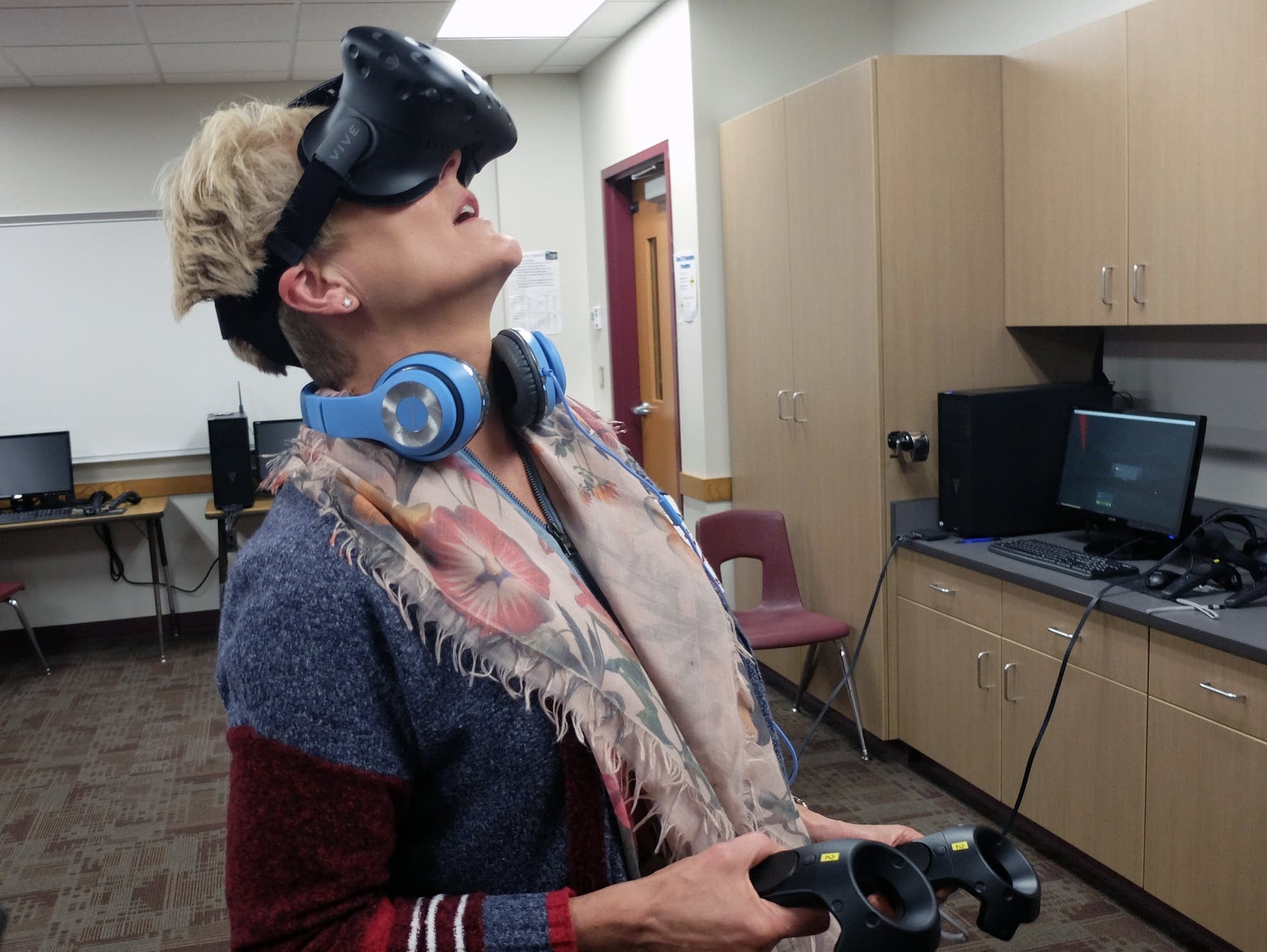 Elementary teacher Tracy Baxter tries out virtual reality goggles.