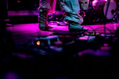 Close up of boots on stage behind cables