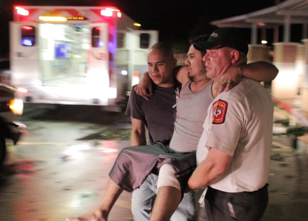 Carrying injured man after tornado