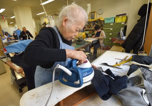 Workers repair clothes at a seniors' work centre in Tokyo.