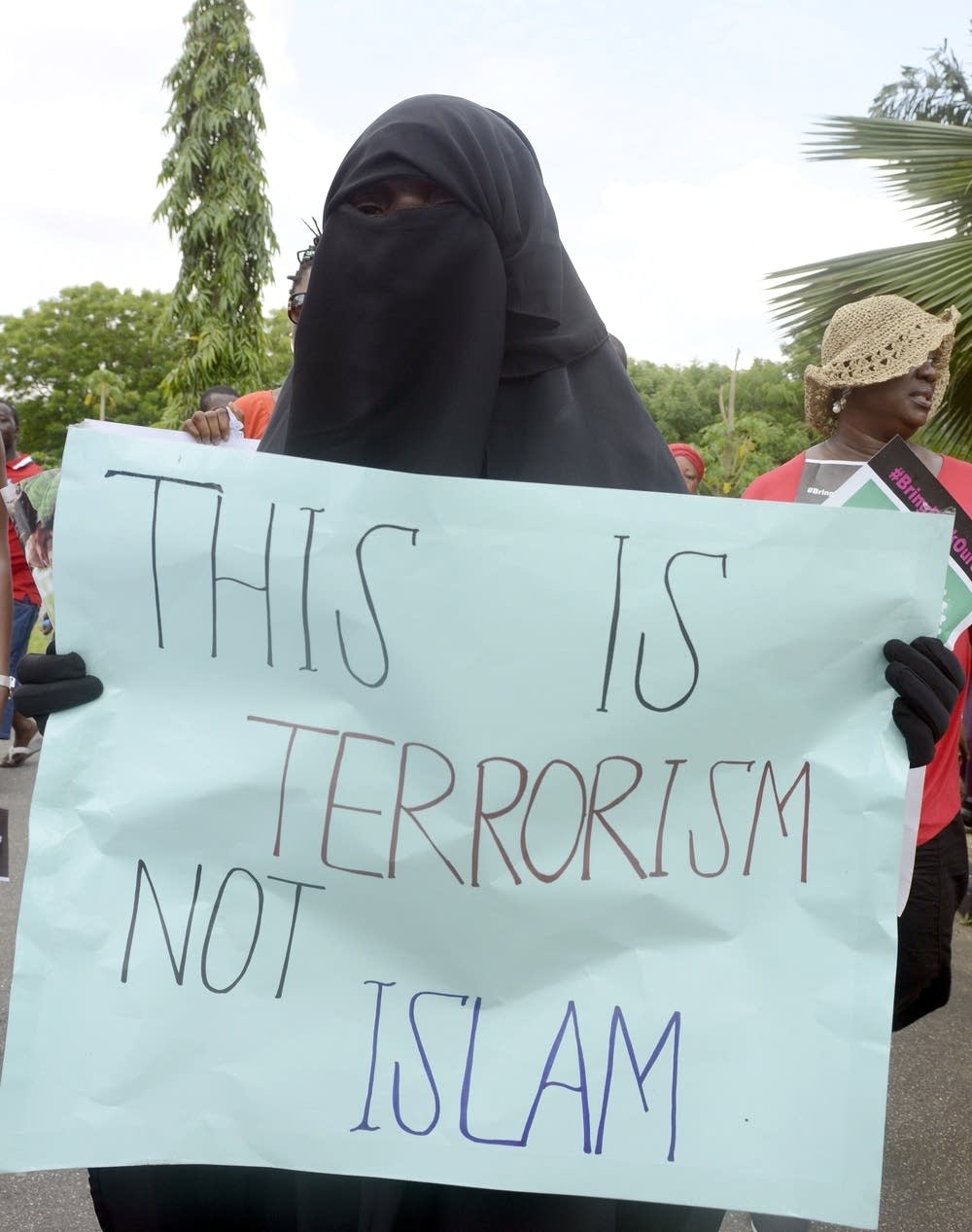 Woman holds sign