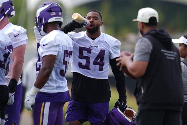 A man hydrates during a camp