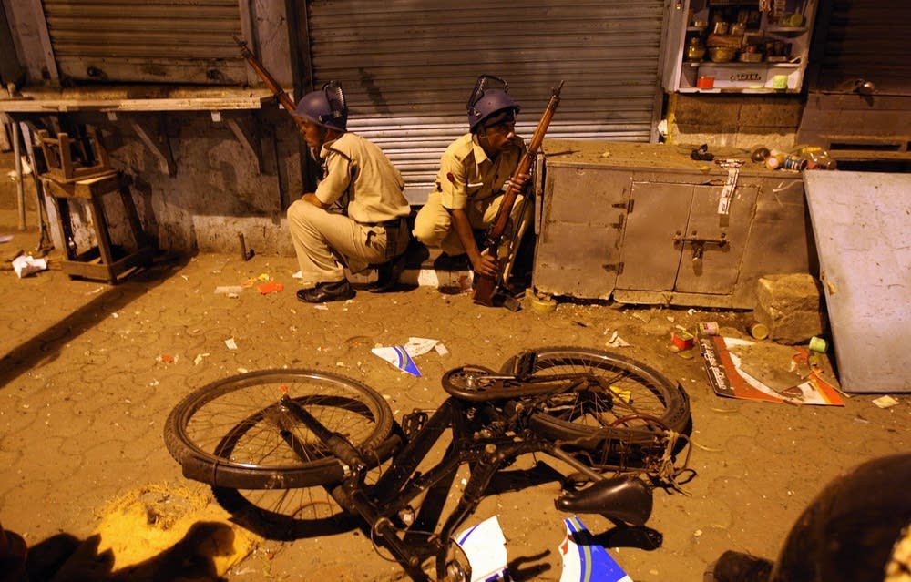 Indian policemen prepare to take position