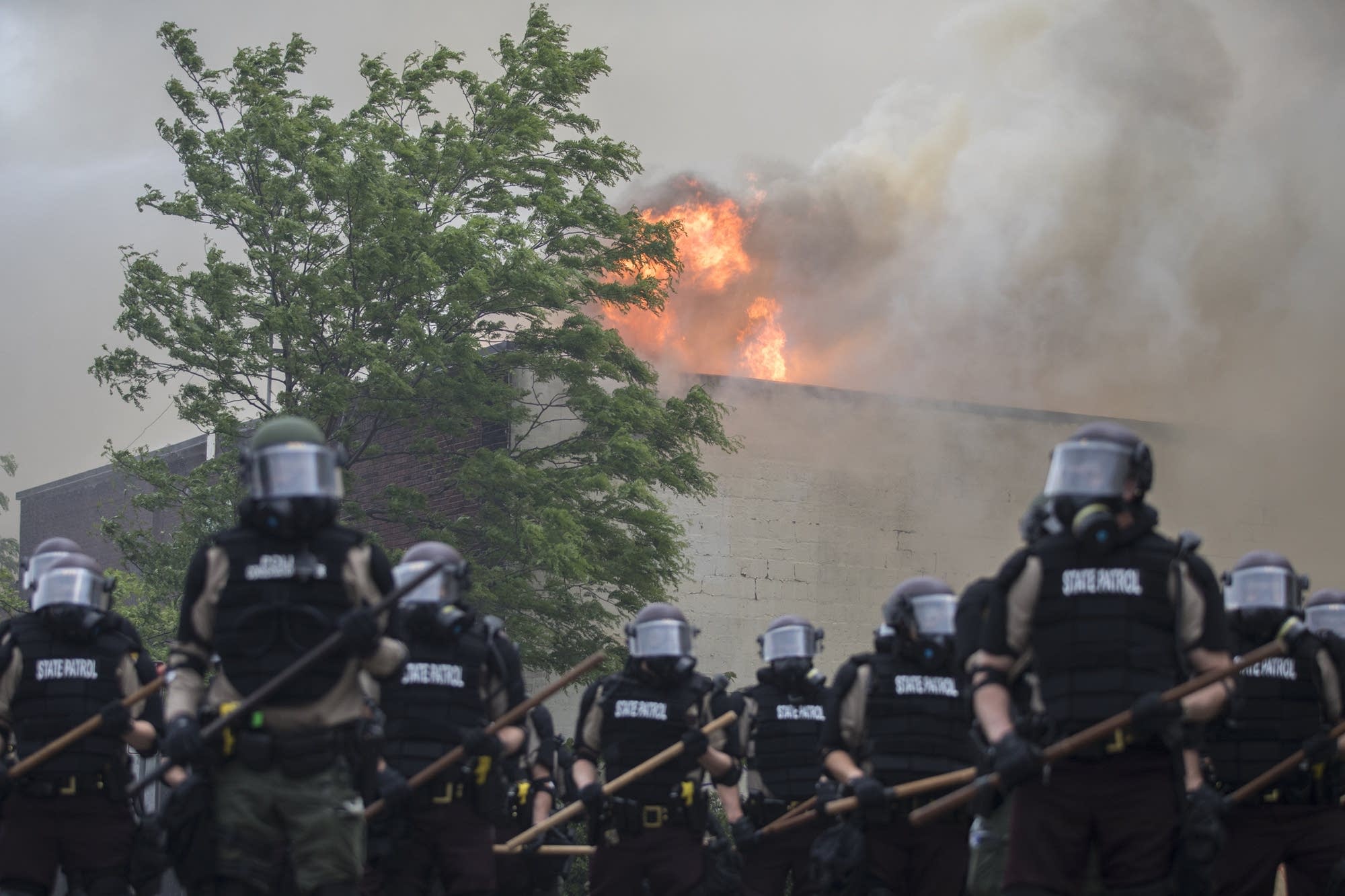 State patrol march in front of buildings