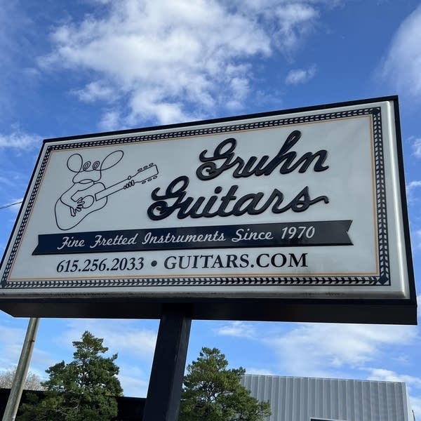 A large sign outside a retailer that reads Gruhn Guitars