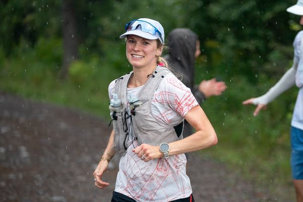 A woman smiles while running