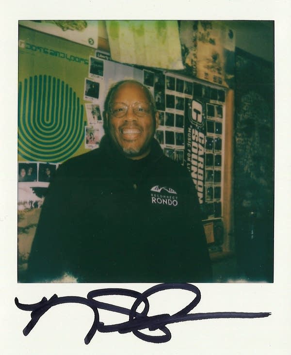 a signed polaroid with a man in it