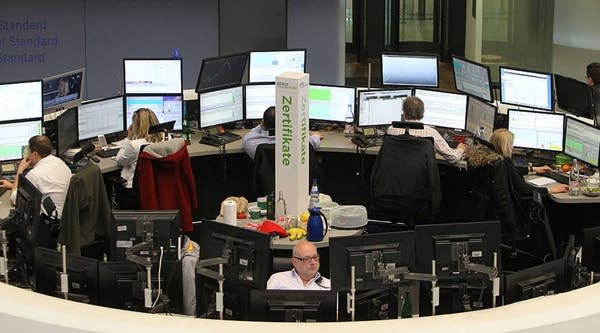 This picture shows brokers at the stock exchange in Frankfurt, Germany, on February 26, 2016. Frankfurt stock exchange operator Deutsche Boerse revealed Friday that in the proposed tie-up with the London Stock Exchange the merged group would be based in the British capital.